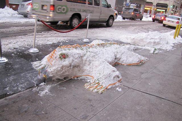 Photograph of a snow lizard emerging from the street by katieknitsny on Flickr